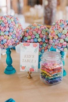 the table is set up with colorful candy and cards for guests to write on it