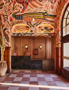 an ornately decorated lobby with checkered flooring and wooden paneled walls is pictured