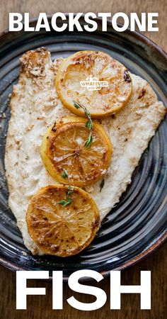 fish with lemon slices and herbs on a blue plate that reads, blackstone fish