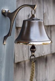 a bell hanging from the side of a building