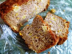 two slices of banana bread sitting on top of plastic wrapper next to each other