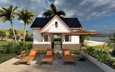 a small white house sitting on top of a lush green field next to the ocean