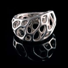 A delicate organic ring inspired by the complex cellular forms of nature and generated by a computer simulation of spring meshes. The final design is built up layer by layer in stainless steel using direct metal 3D printing and infused with bronze. The rings are coated in a plastic clear coat to help prevent oxidization but with use may oxidize over time. SIZE sz 5 circumference 49mm sz 6 circumference 51.5mm sz 7 circumference 54mm sz 8 circumference 56.6mm MATERIAL stainless steel, bronze infu Parametric Jewelry, 3d Printed Ring, 3d Printed Jewelry, Layered Rings, Organic Rings, Printed Jewelry, Twist Ring, Nature Inspired Jewelry, Stainless Steel Rings