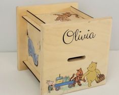 a wooden toy box with winnie the pooh and friends on it's sides