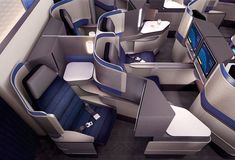 the inside of an airplane with blue and gray seats