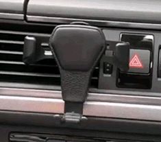 a car dashboard with an air vent and control panel in the center, showing it's buttons