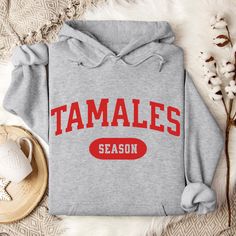 ORDERS PLACED AFTER DEC 10TH ARE NOT GUARANTEED TO ARRIVE BY DEC 24TH - HOLIDAY SHIPPING TIMES ARE UNPREDICTABLE AS WE GET CLOSER TO CHRISTMAS ORDERS PLACED AFTER DEC 10TH ARE NOT GUARANTEED TO ARRIVE BY DEC 24TH - HOLIDAY SHIPPING IS UNPREDICTABLE AS WE GET CLOSER TO CHRISTMAS Mexican Christmas Sweatshirt - Enjoy your Christmas Holidays with this fun Tamales Season Hoodie. A perfect gift for Mexican mom or Latinos who embrace these traditional delicacies during the Holidays.  * 50% cotton, 50% Christmas Cotton Hoodie With Letter Print, Game Day Winter Hoodie Sweatshirt, Letter Print Hoodie For Winter Fan Apparel, Winter Fan Apparel Hoodie With Letter Print, Winter Hoodie With Letter Print For Fans, Winter Hoodie With Letter Print Fan Apparel, Latina Vibes, Spanish Shirts, Hispanic Culture