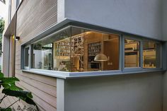 the inside of a house that is lit up with lights and bookshelves in it