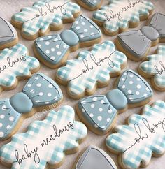 some cookies are decorated with blue and white bow ties on them for baby shower favors