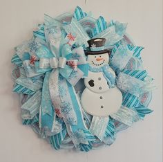 a snowman wreath hanging on the wall