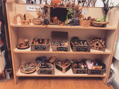 a shelf filled with lots of different types of baskets on top of wooden shelves next to each other