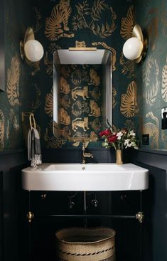 a white sink sitting under a bathroom mirror next to a wall mounted faucet