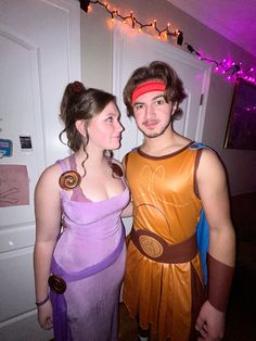 two people dressed in costumes standing next to each other