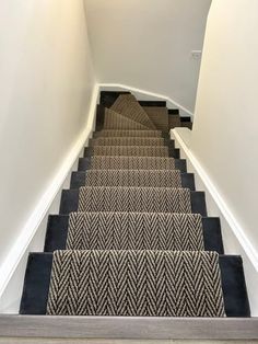 a staircase with carpeted steps leading up to the top