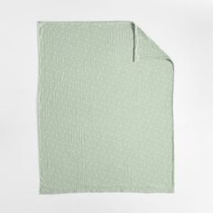 a green blanket with white dots on it