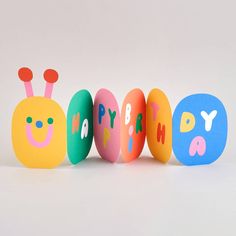 three colorful eggs with the words happy birthday written on them in different colors and shapes