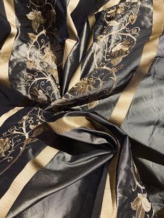 Duchess Jezebel 100% Silk Taffeta Embroidery Fabric - Dark Grey & Gold - Fancy Styles Fabric Pierre Frey Lee Jofa Brunschwig & Fils Elegant Gold Embroidered Raw Silk Fabric, Elegant Brocade Dupatta With Gold Embroidery, Elegant Black Brocade Dupatta, Black Embroidered Raw Silk Fabric, Elegant Silk Fabric With Gold Embroidery, Black Raw Silk Fabric Embroidered, Elegant Brocade Fabric With Gold Embroidery, Black Silk Fabric With Zari Embroidery, Elegant Traditional Drape Embroidered Gold Fabric