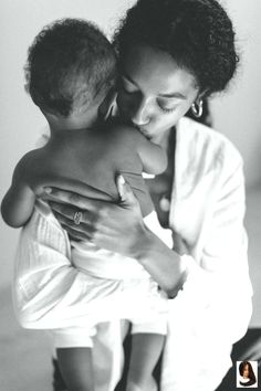 a woman holding a baby in her arms