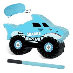 a blue shark shaped pinata next to a black marker and pen on a white background