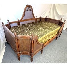 an old fashioned bed with wicker frame and foot board is displayed on the floor