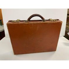 Vintage T. Anthony Leather Briefcase made in Englund. Classic attache for that working man or woman. Iconic simple design. Signed on it's hunter green interior. Perfect prop for that 1980's movie or that collector.  Dimensions: Height:12.75 in (32.39 cm) Width: 17 in (43.18 cm)Depth: 3.75 in (9.53 cm) Materials and Techniques: Leather Period: 1980-1989 Date of Manufacture: 1980-1989 Condition: Good, Wear consistent with age and use. Vintage Brown Rectangular Briefcase For Formal Use, Vintage Brown Rectangular Briefcase For Formal Occasions, Vintage Brown Leather Case, Rectangular Vintage Brown Briefcase For Formal Occasions, Retro Leather Briefcase For Office, Vintage Brown Leather Cases, Vintage Leather Business Cases, Vintage Leather Rectangular Briefcase, Vintage Leather Case For Business Trips