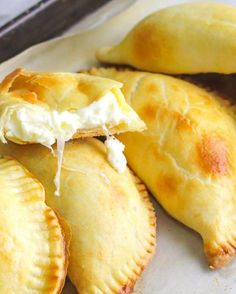 several pastries on a white plate with a knife in the backgrouf