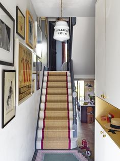 an instagram page with stairs and pictures on the wall, below which is a hallway