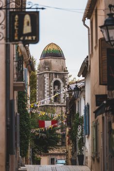 an alley way with buildings and flags on it