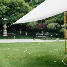 a white tent with lights hanging from it's sides