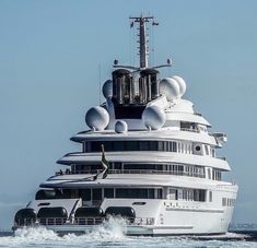 a large white boat in the middle of the ocean with lots of windows on it