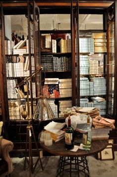 a room filled with lots of books and furniture