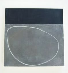 an abstract painting with white lines on a black and gray background, against a white wall