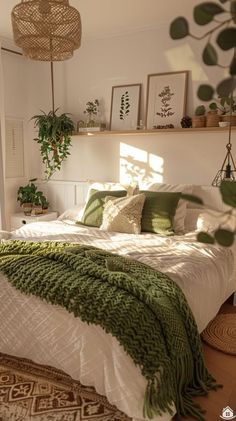 a bed with green blankets and pillows in a bedroom