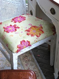 a white desk with a flowered chair cushion