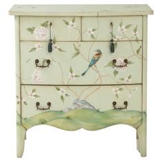 a painted dresser with birds and flowers on it's drawers, one drawer is open