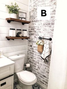 a white toilet sitting in a bathroom next to a sink and shelves filled with towels