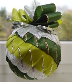 a green and white ornament hanging from a window