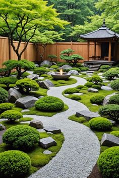 a garden with rocks, grass and trees