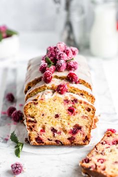 a loaf of raspberry pound cake with frosting and fresh raspberries on top