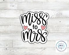 the word miss to mrs with hearts in black and pink on a white wood background