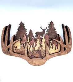 an image of a deer in the woods with trees on it's back side