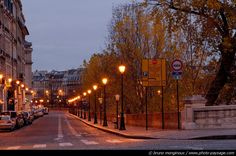 an empty street at dusk with no cars on it