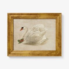 a white swan with red berries in its beak is hanging on the wall next to a gold frame