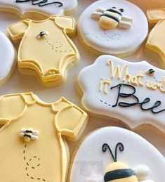 decorated cookies with baby clothes and bees on them