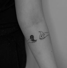 a black and white photo of a person's arm with a tattoo on it