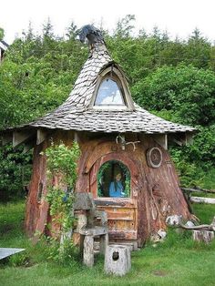 an image of a small house made out of tree stumps in the woods with text overlay