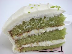 a piece of cake with white frosting and green sprinkles on top