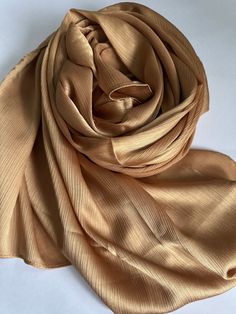 STUNNING LUXURY SOFT DEEP GOLD SCARF Beautiful delicate soft lightweight textured scarf This scarf is a perfect accessory for both daytime and evening wedding wear worn as a shawl & wrap  Made from silk 30% Viscose 70% colour-Deep Gold   188cm length x 140cm width (approx)  Note: The colour of the scarf may appear slightly different in person as screen settings and lighting can affect how it looks on the phone or computer. Wear Shawl, Gold Scarf, Silk Shawl, Wrap Scarf, Evening Wedding, Shawl Wrap, Crochet Edging, Champagne Gold, Dresses To Wear To A Wedding