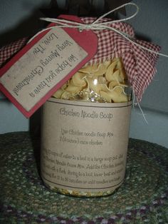 a jar filled with pasta sitting on top of a table next to a red tag