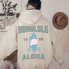 Hawaii Honolulu Hoodie For Woman For Man Vintage Surfing Hoodie Aesthetic Hoodie Blue Hoodie Trendy Hoody Beach Sweatshirt Coconut Girl Hoodie 🖤 For oversized order 1-3 sizes up, refer to listing photos for sizes. RUNS ON THE SMALLER SIDE 🖤 Gildan 18500 🖤 Some Shrinkage may occur with washing 🖤 No design in the front of the hoodie This unisex heavy blend hooded sweatshirt is relaxation itself. Made with a thick blend of cotton and polyester, it feels plush, soft and warm, a perfect choice for any cold day. In the front, the spacious kangaroo pocket adds daily practicality while the hood's drawstring is the same color as the base sweater for extra style points. .: 50% cotton, 50% polyester .: Medium-heavy fabric (8.0 oz/yd² (271 g/m .: Classic fit .: Tear-away label .: Runs true to size Beach Hoodies, Hawaiian Girl, Vintage Surfing, Light Blue Hoodie, Hawaii Honolulu, Girl Hoodie, Beach Sweatshirt, Sweatshirt Aesthetic, Hoodie Aesthetic